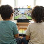 two kids playing a gaming console